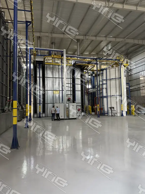 Interior of a coating plant with vertical booths and overhead conveyor