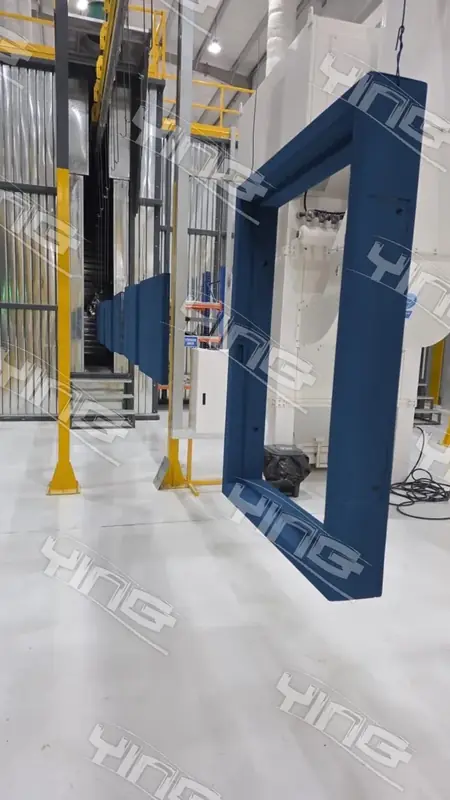 Large fabricated frame suspended at the entrance of a coating booth