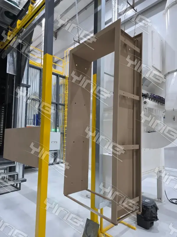 Large panel suspended inside a powder coating booth