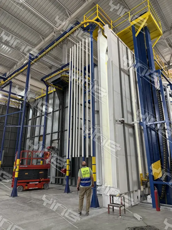 Vertical powder coating line and load bay inside a finishing plant