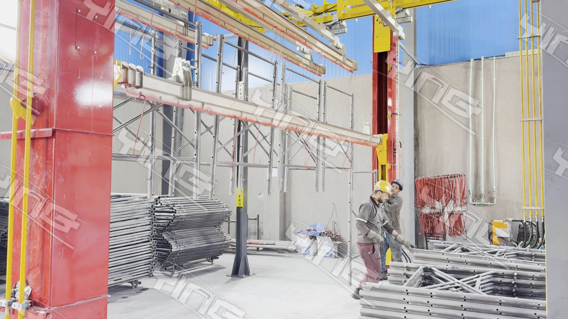 Operators hanging scaffolding frames on a load bar lowered to floor level beside the red elevator lifter at ACROW Misr